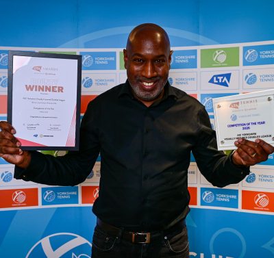 Man holding trophies