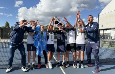 Boys tennis team celebrate winning trophy