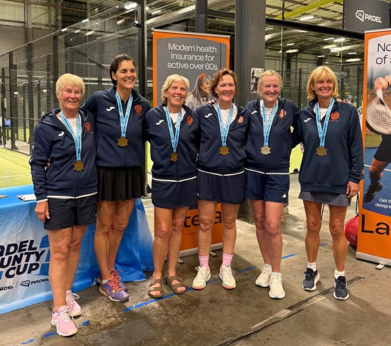 Group pd women wearing medals on padel court