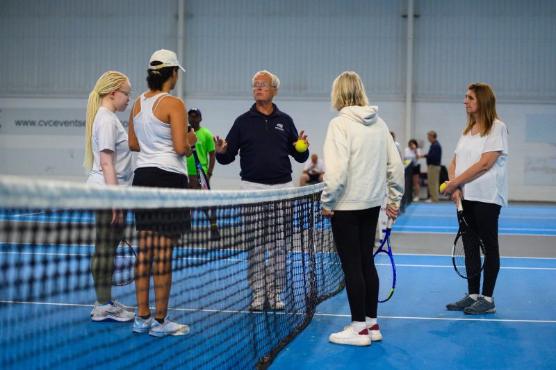 Players and umpire on tennis court