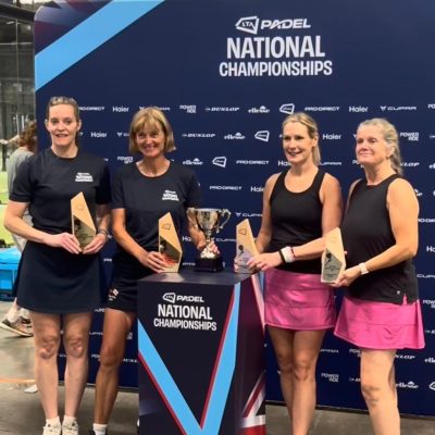 Four women players holding trophies and medals at national padel championships